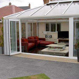 Large conservatory with open uPVC bi fold doors