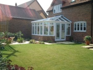 Victorian conservatory in a neat garden